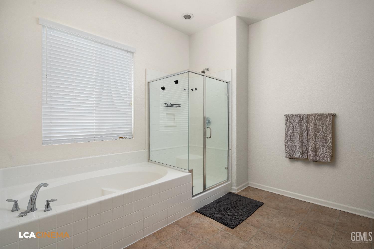 Undisclosed Address Bakersfield, CA 93314 - Photo 26 of 29 a bathroom with a bathtub and a shower