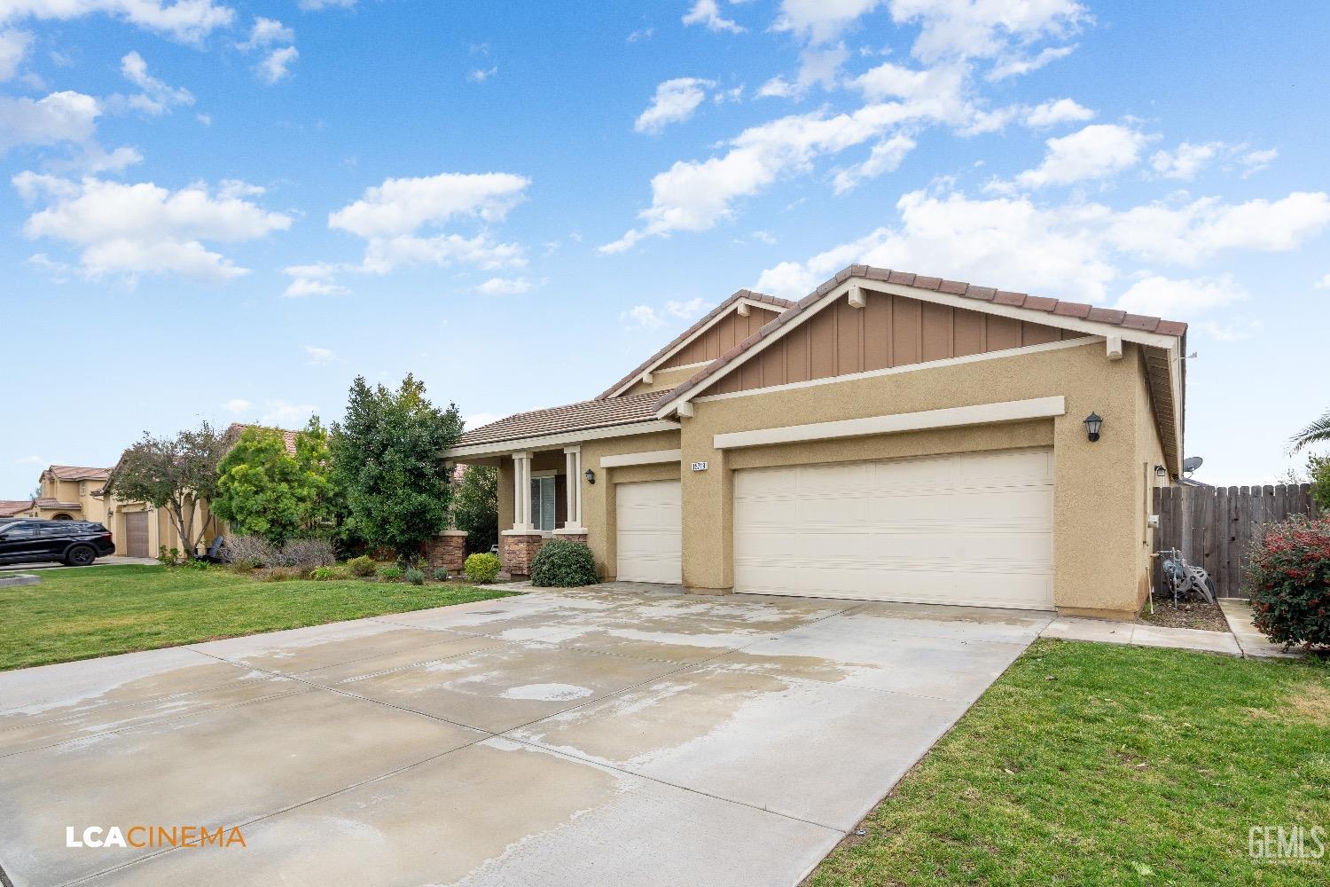 Undisclosed Address Bakersfield, CA 93314 - Photo 4 of 29 a front view of a house with a garden