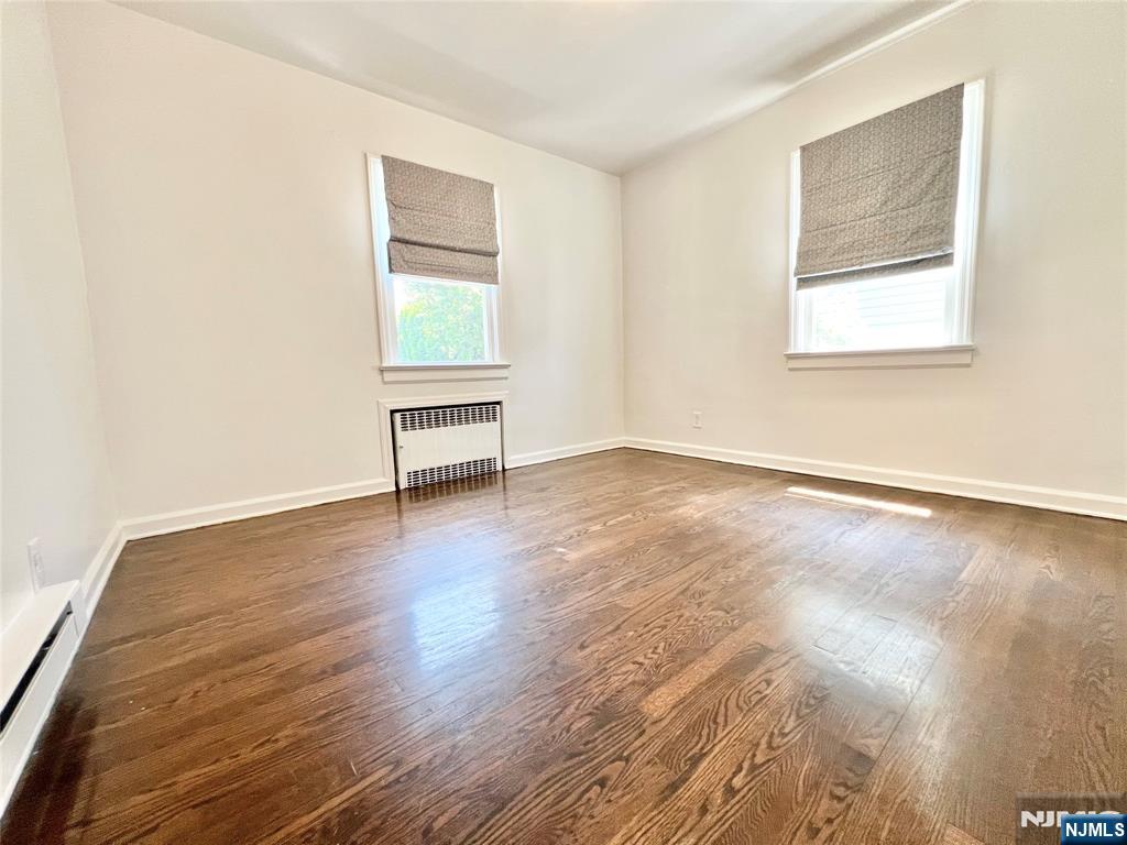 18 Pershing Street Garfield, NJ 07026 - Photo 10 of 16 a view of an empty room with wooden floor and a window