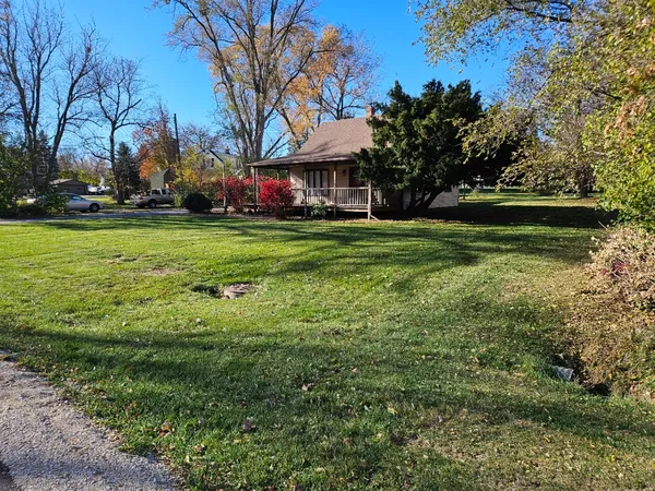 a view of house with garden space and trees
