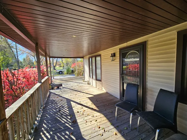 a porch with seating space and wooden floor