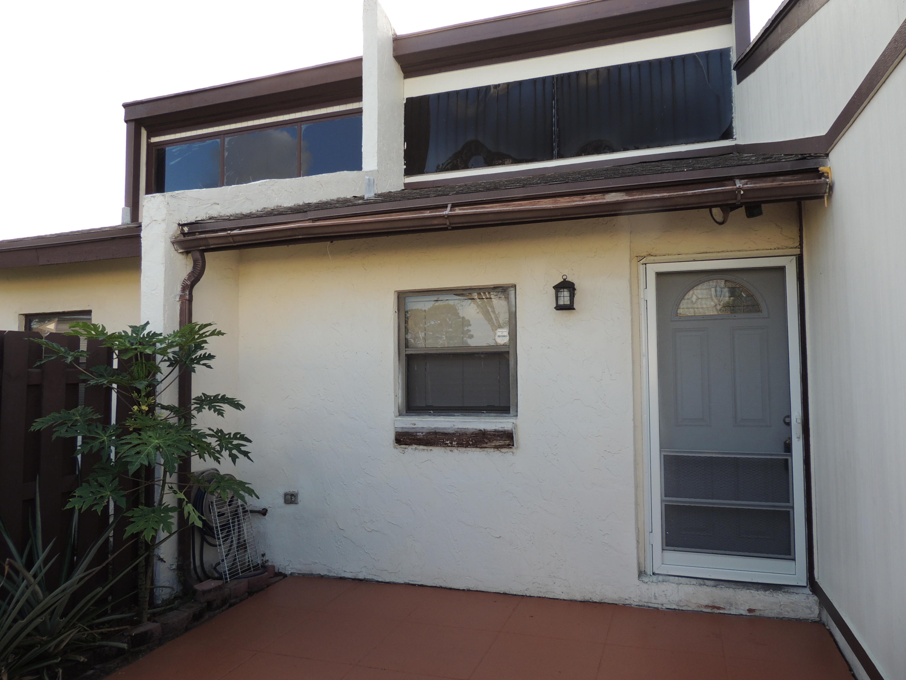 1829 Abbey Road West Palm Beach, FL 33415 - Photo 1 of 15 a house with a potted plant on it