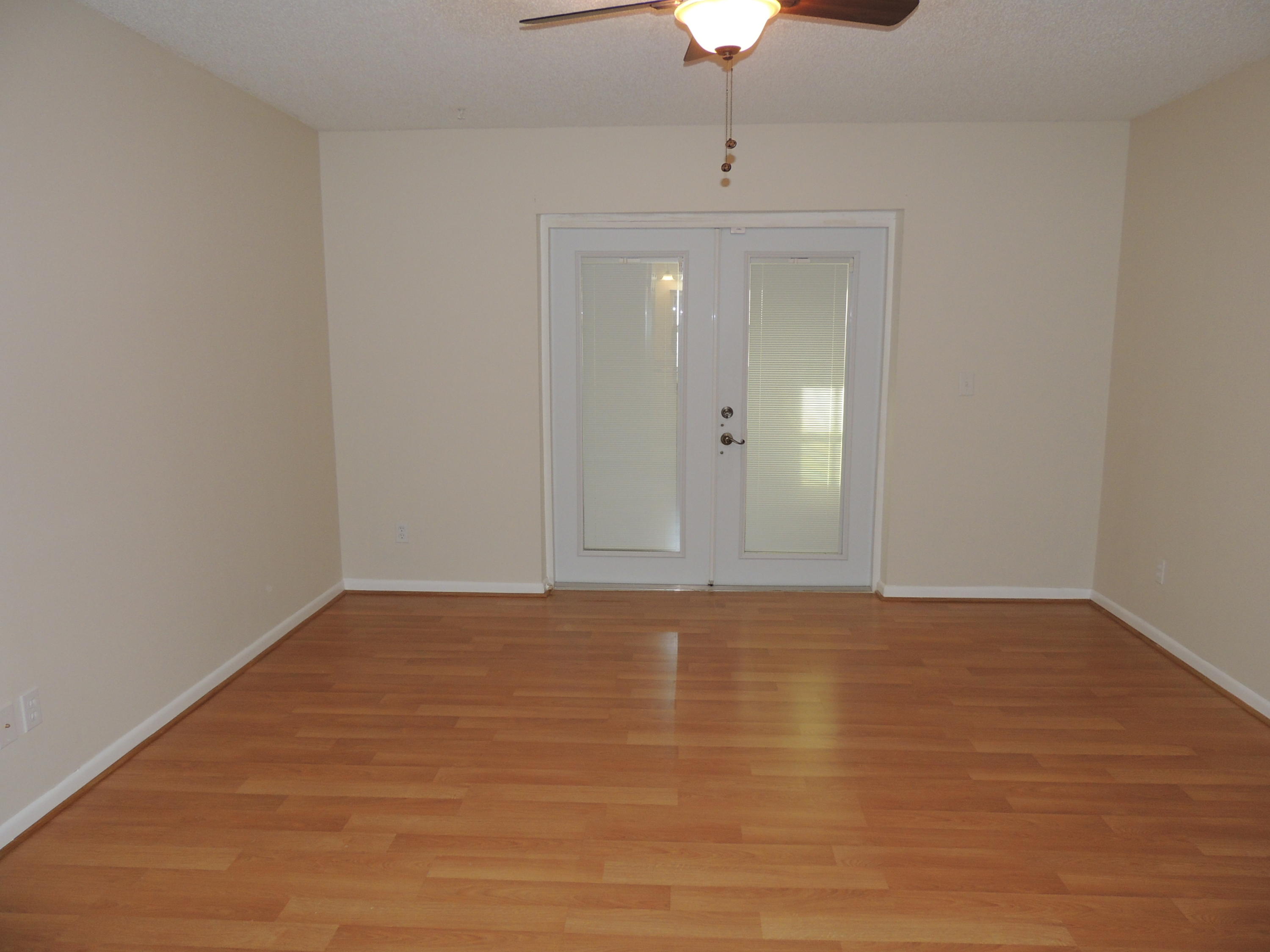 1829 Abbey Road West Palm Beach, FL 33415 - Photo 11 of 15 a view of an empty room with chandelier fan and wooden floor