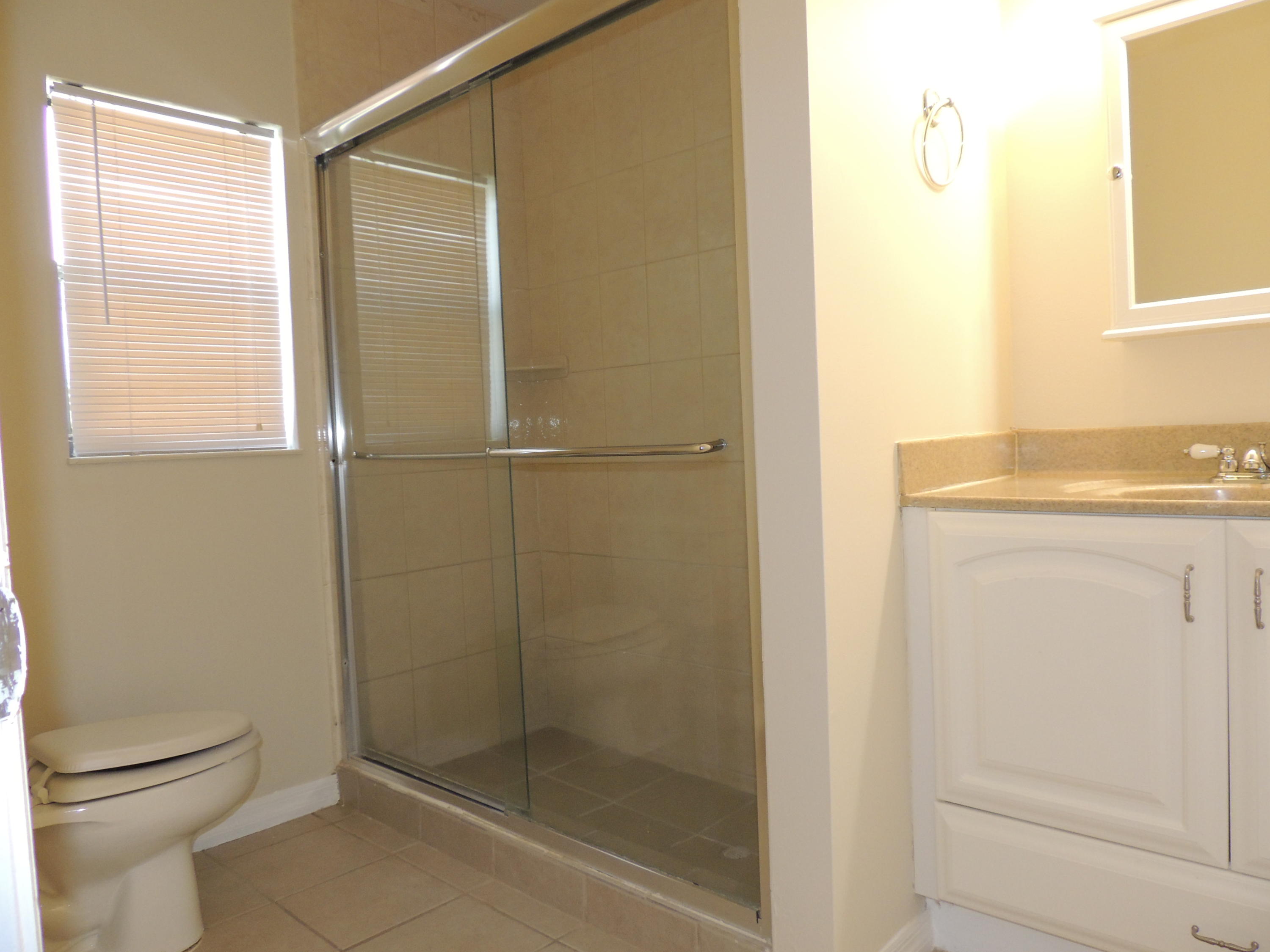1829 Abbey Road West Palm Beach, FL 33415 - Photo 13 of 15 a bathroom with a shower a toilet and a sink