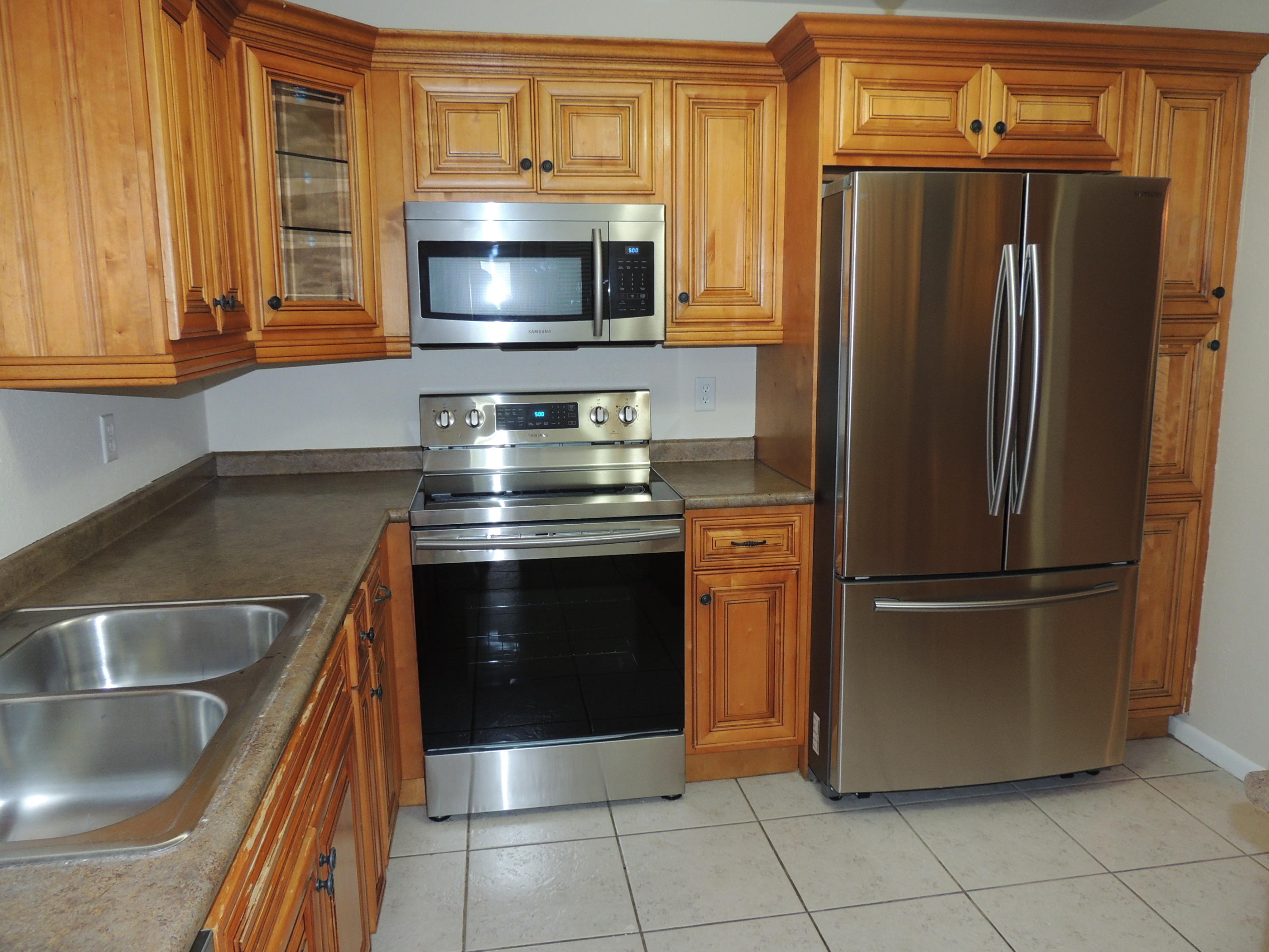 1829 Abbey Road West Palm Beach, FL 33415 - Photo 4 of 15 a kitchen with granite countertop a stainless steel stove and refrigerator