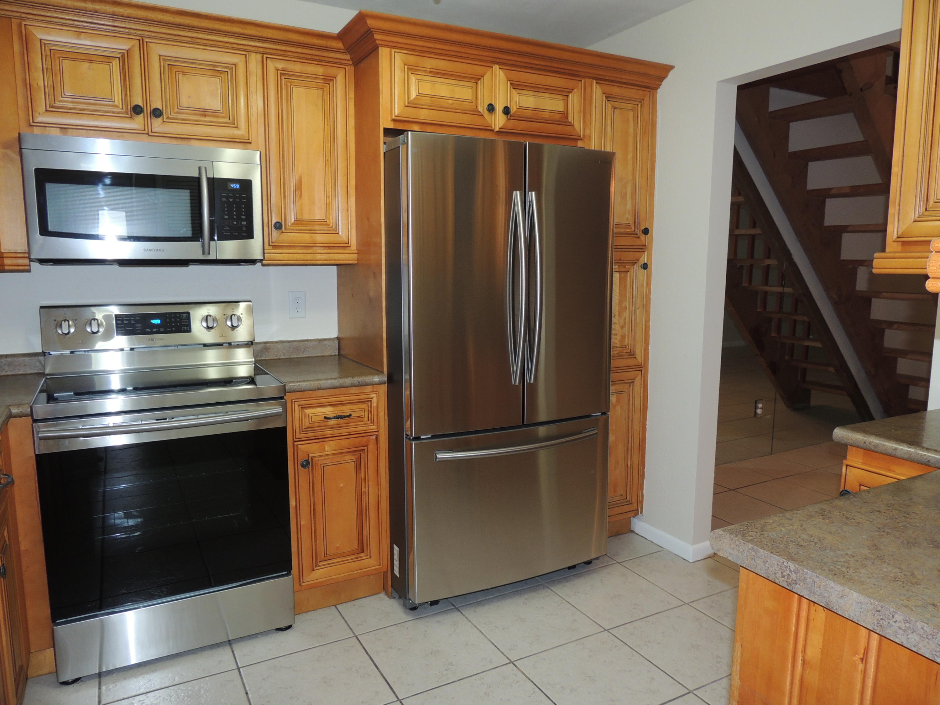 1829 Abbey Road West Palm Beach, FL 33415 - Photo 7 of 15 a kitchen with stainless steel appliances granite countertop a refrigerator and a stove top oven