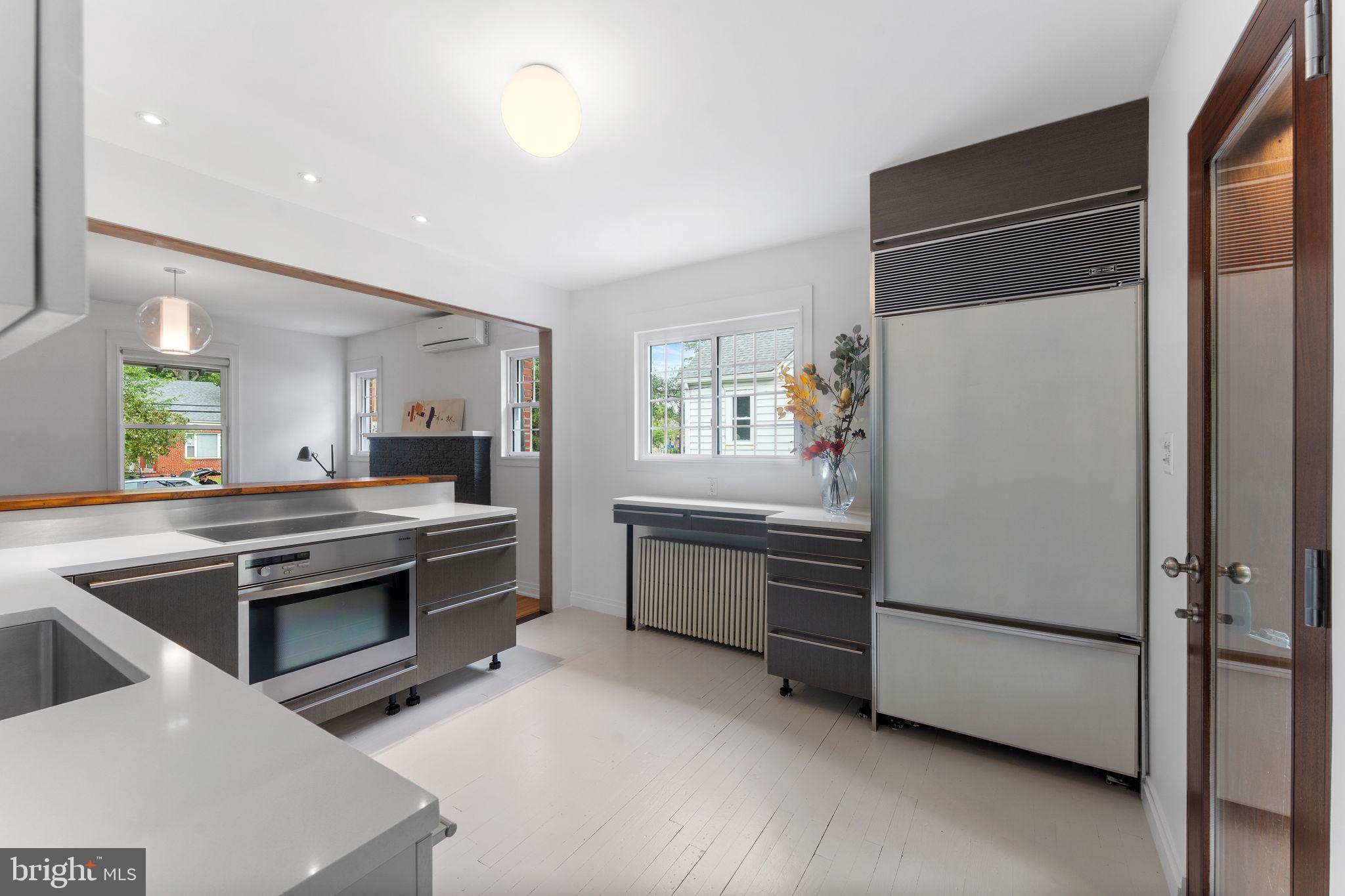 5807 Taylor Road Riverdale, MD 20737 - Photo 12 of 66 a kitchen with a sink and white cabinets