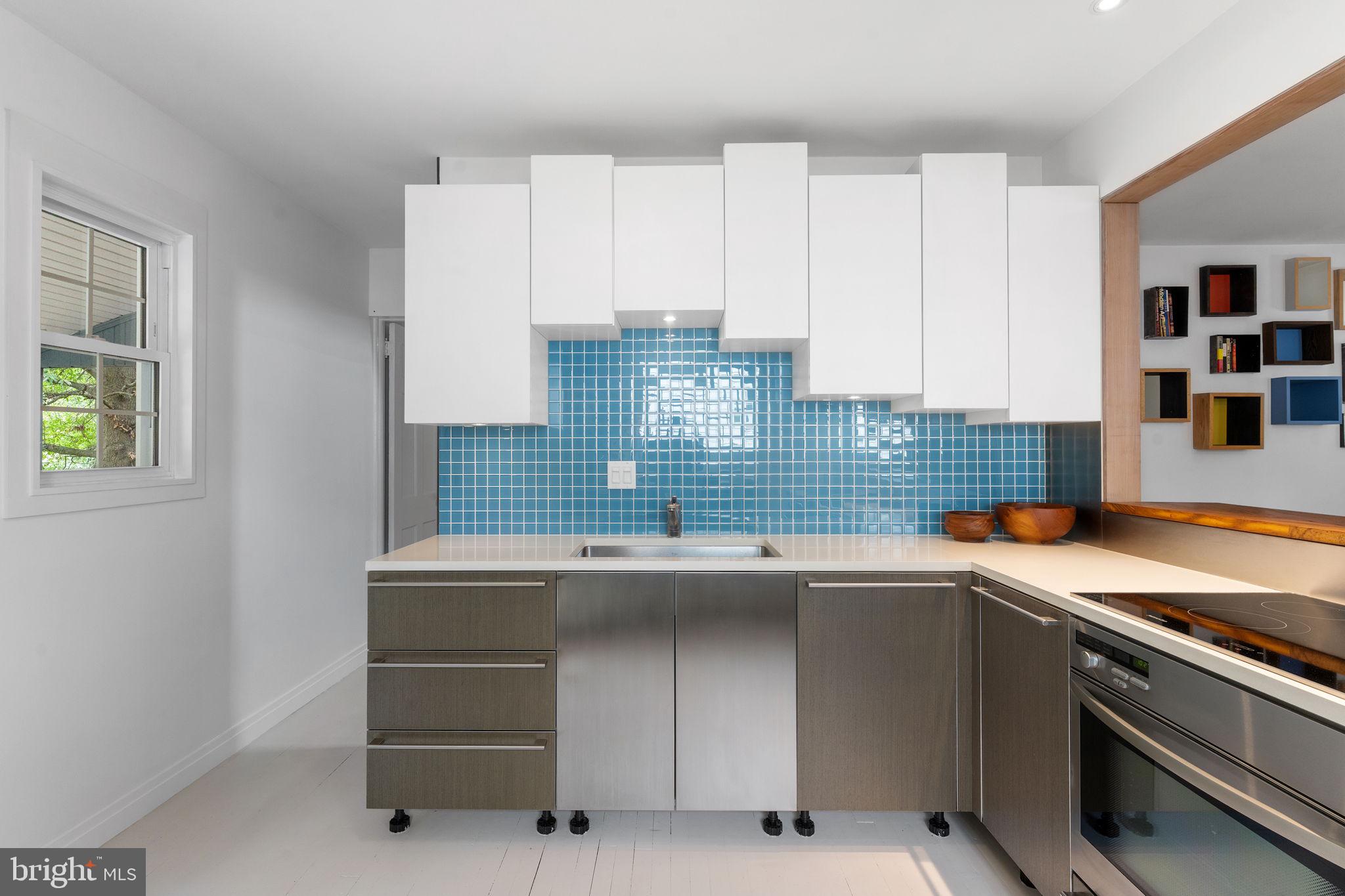5807 Taylor Road Riverdale, MD 20737 - Photo 17 of 66 a kitchen with stainless steel appliances granite countertop a sink and a stove
