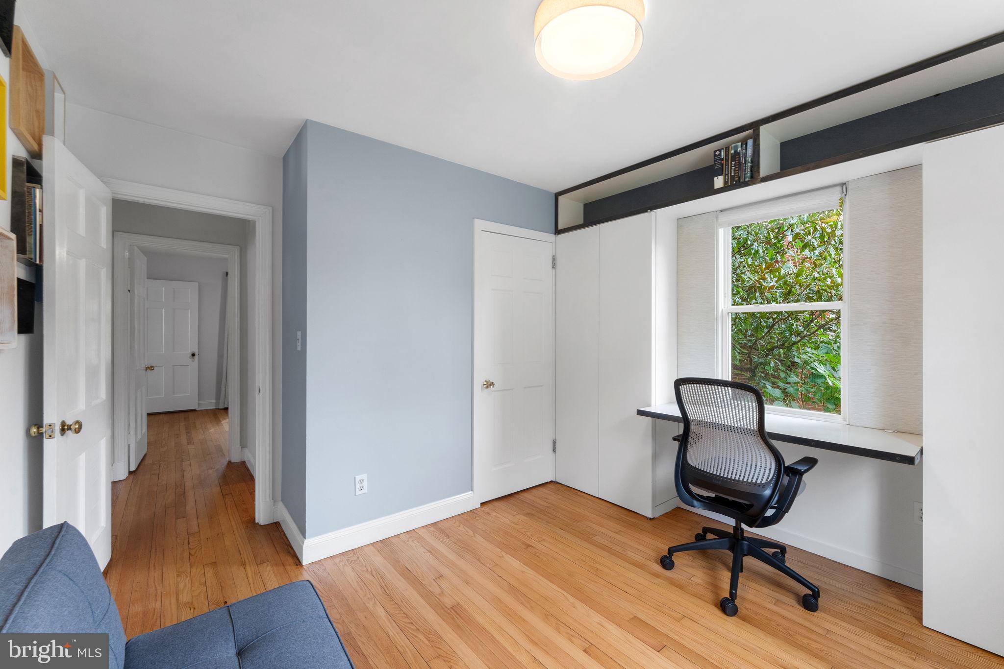 5807 Taylor Road Riverdale, MD 20737 - Photo 19 of 66 a view of a workspace with wooden floor and a window