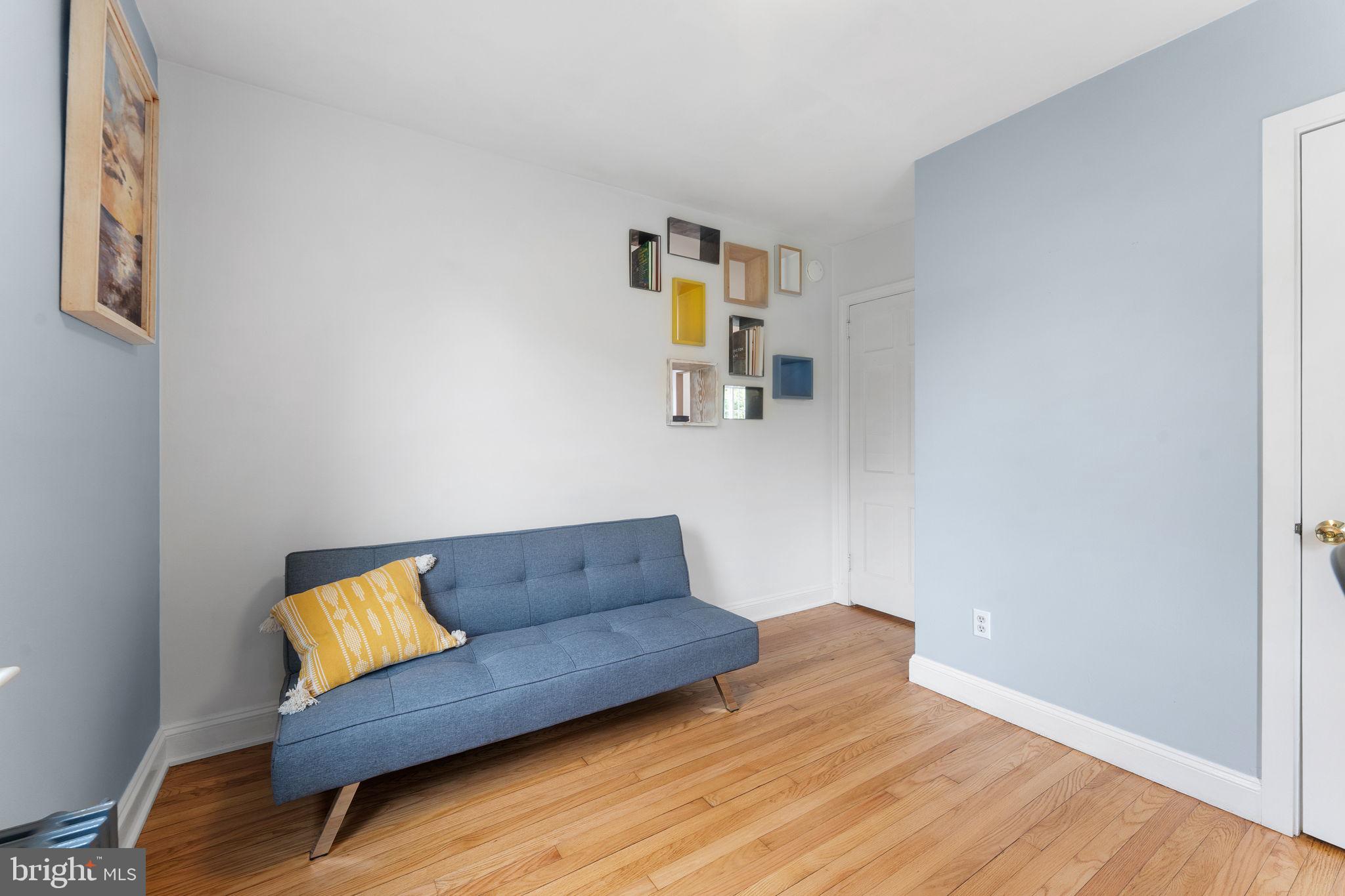 5807 Taylor Road Riverdale, MD 20737 - Photo 20 of 66 a living room with a couch and wooden floor