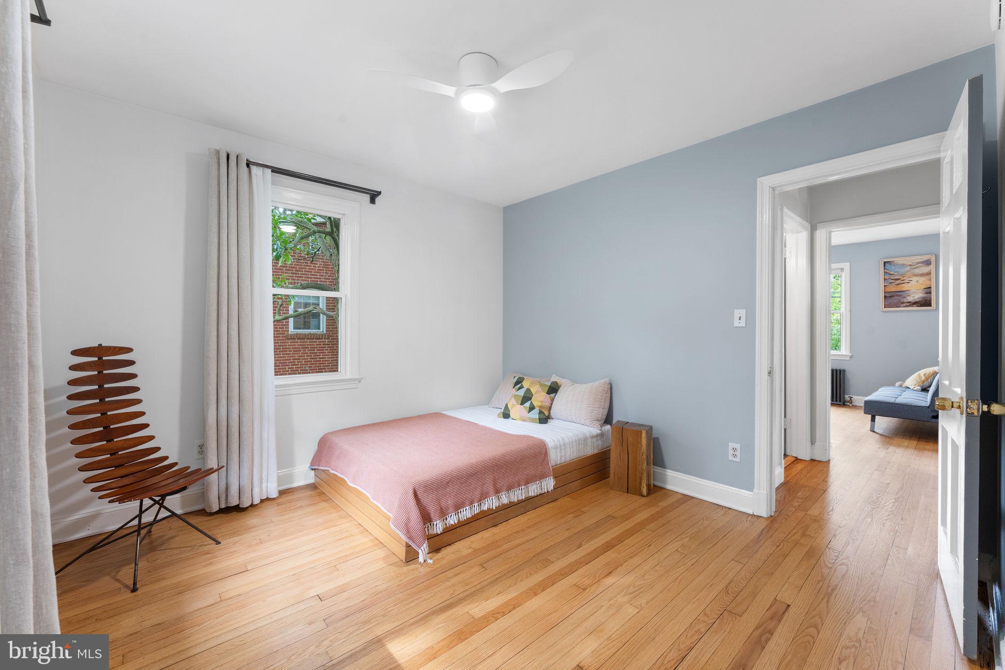 5807 Taylor Road Riverdale, MD 20737 - Photo 22 of 66 a bedroom with two beds and a chandelier