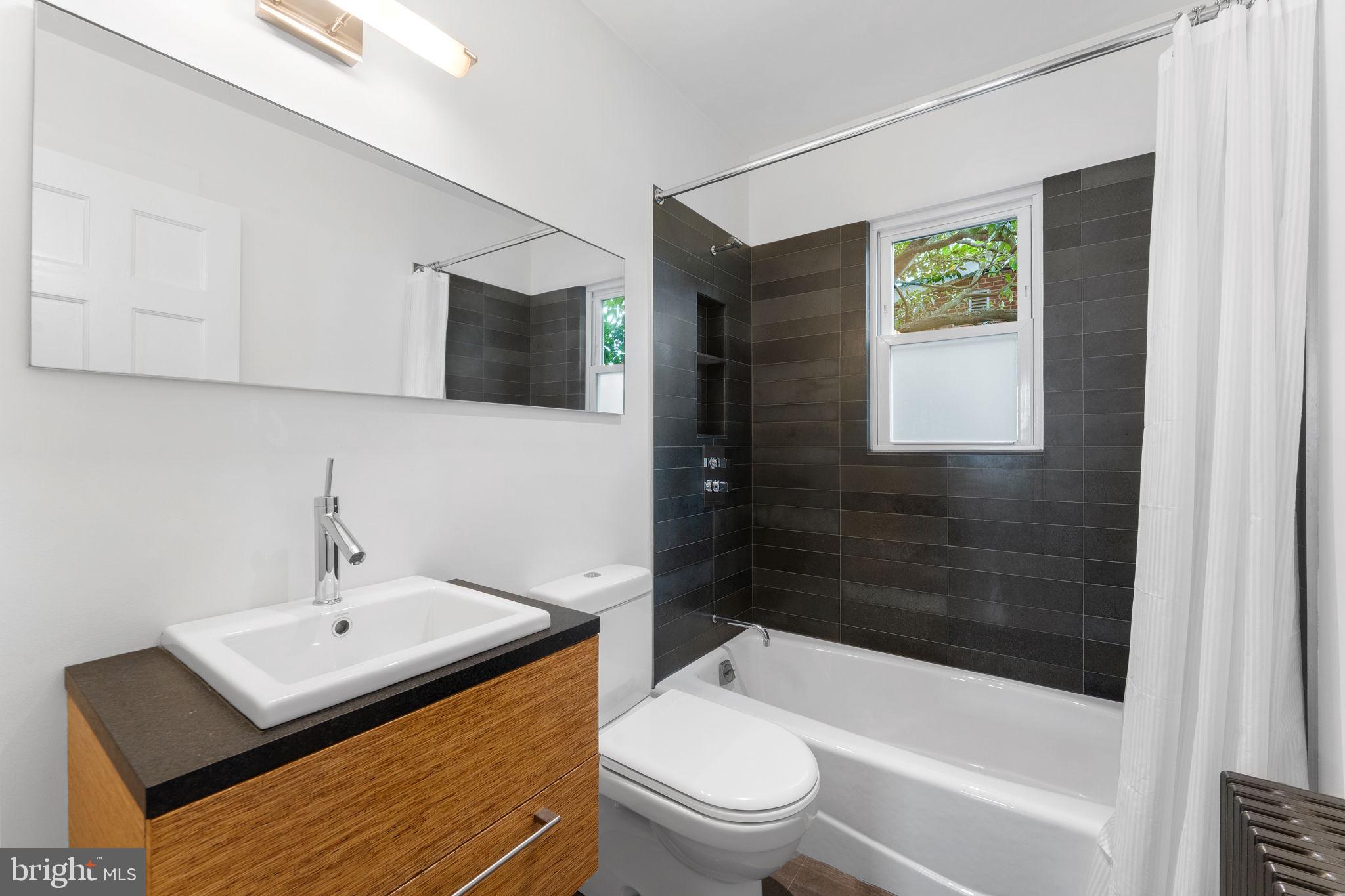 5807 Taylor Road Riverdale, MD 20737 - Photo 24 of 66 a bathroom with a sink toilet and shower