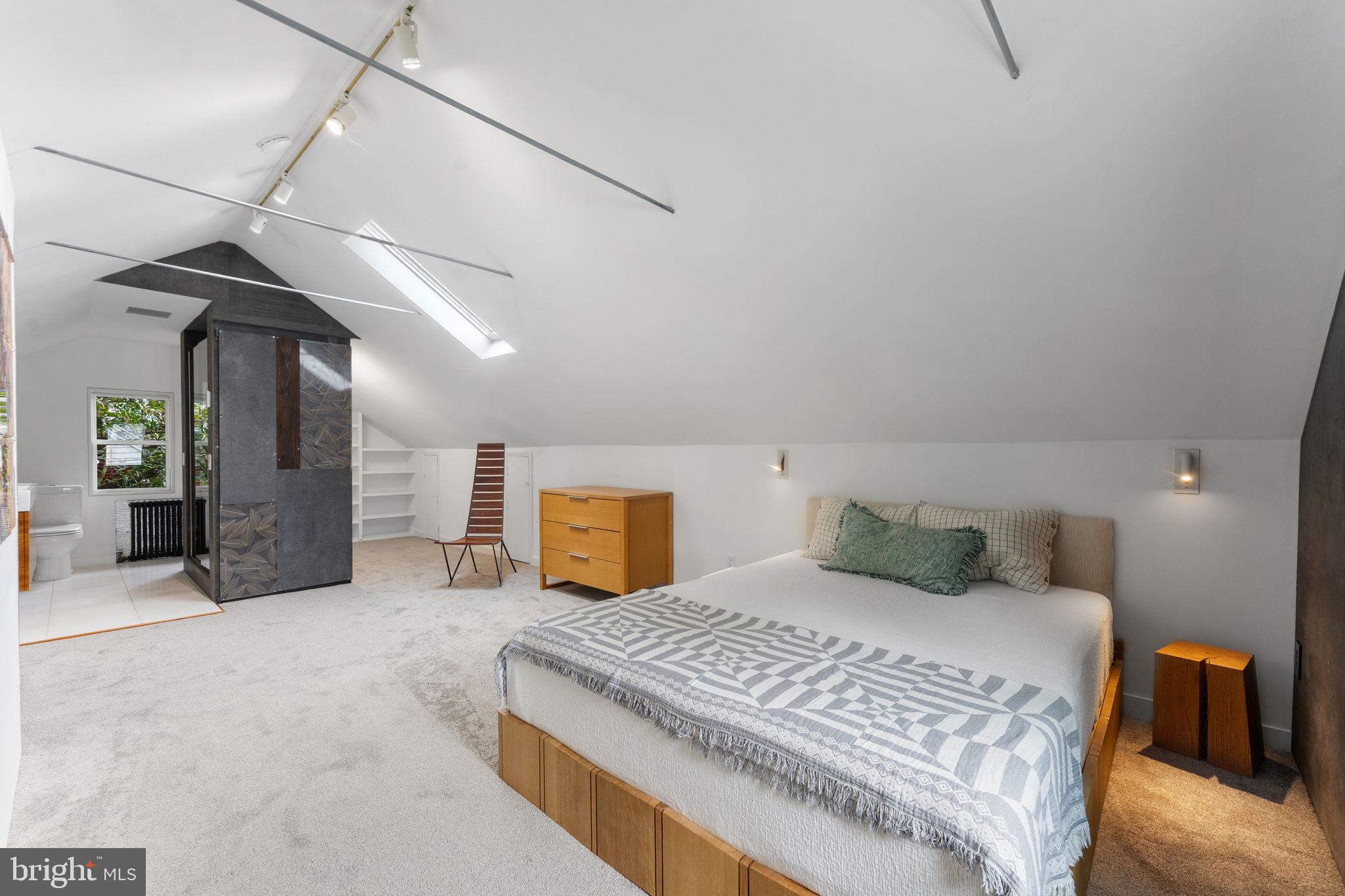 5807 Taylor Road Riverdale, MD 20737 - Photo 30 of 66 a bedroom with a large bed and a chandelier