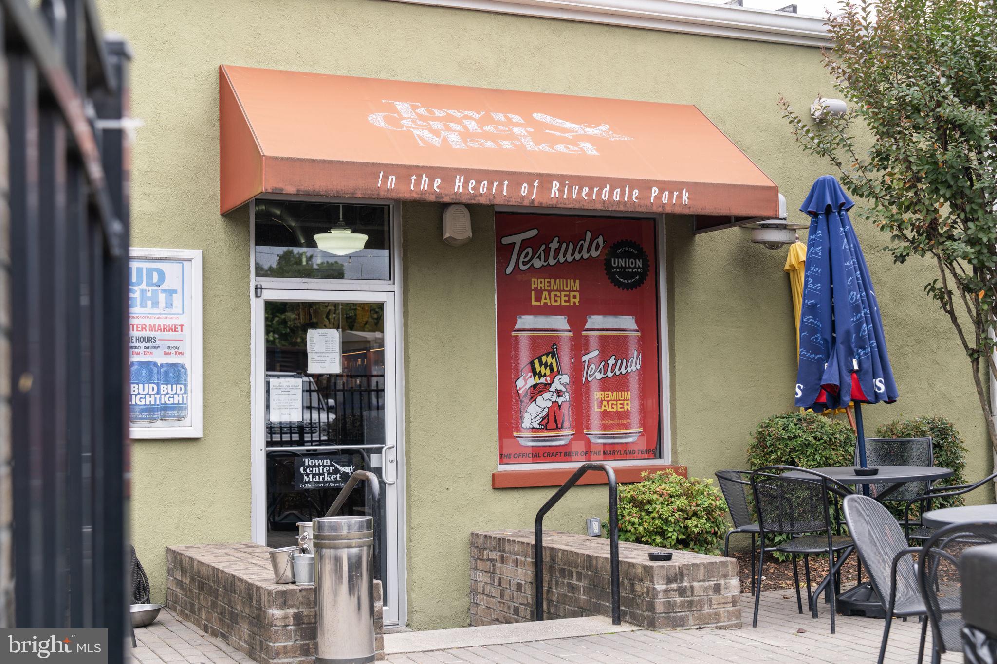 5807 Taylor Road Riverdale, MD 20737 - Photo 54 of 66 a front view of a multi story building with yard and seating area