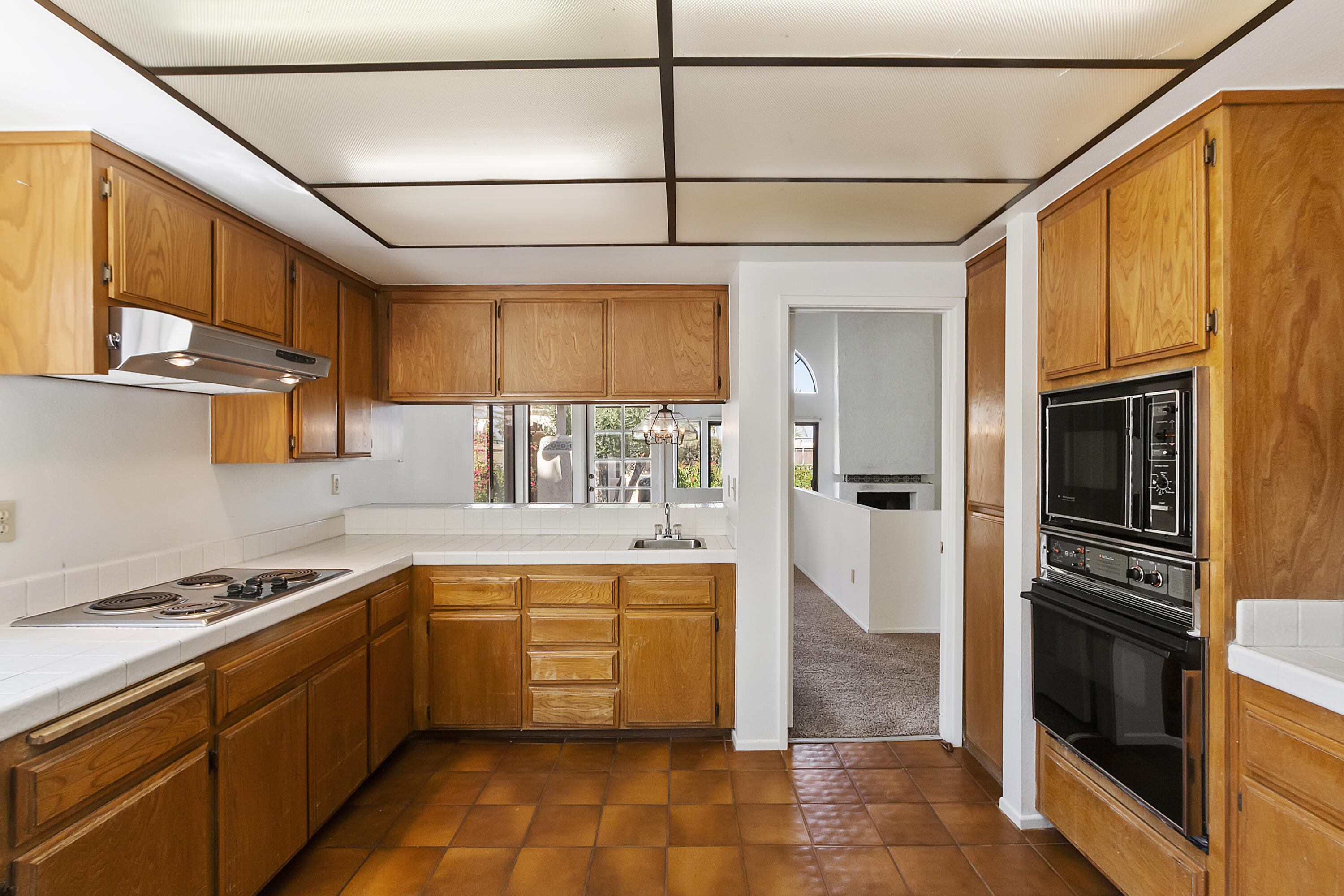 73472 Shadow Mountain Drive Palm Desert, CA 92260 - Photo 13 of 35 a kitchen with stainless steel appliances a stove sink and cabinets