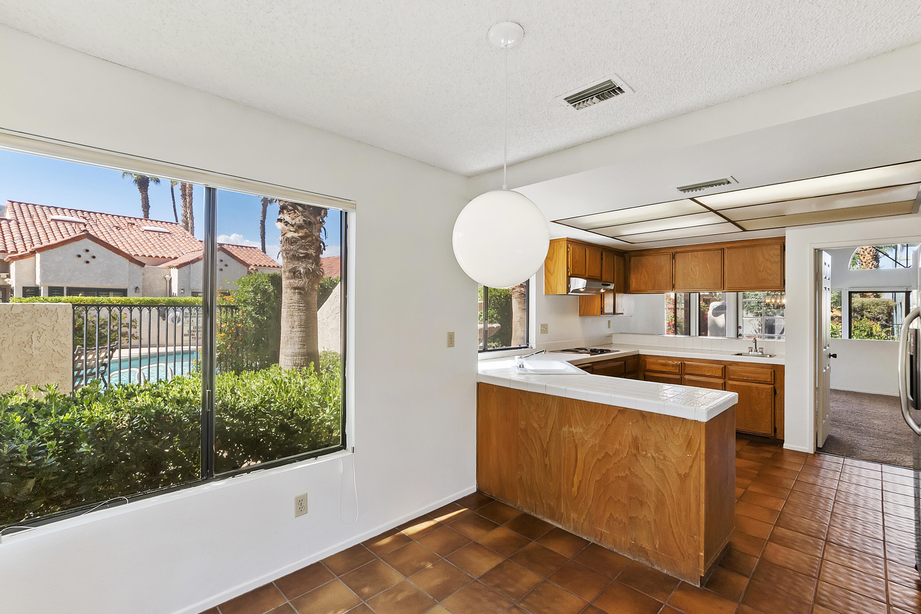 73472 Shadow Mountain Drive Palm Desert, CA 92260 - Photo 15 of 35 a kitchen with stainless steel appliances granite countertop a sink and a stove
