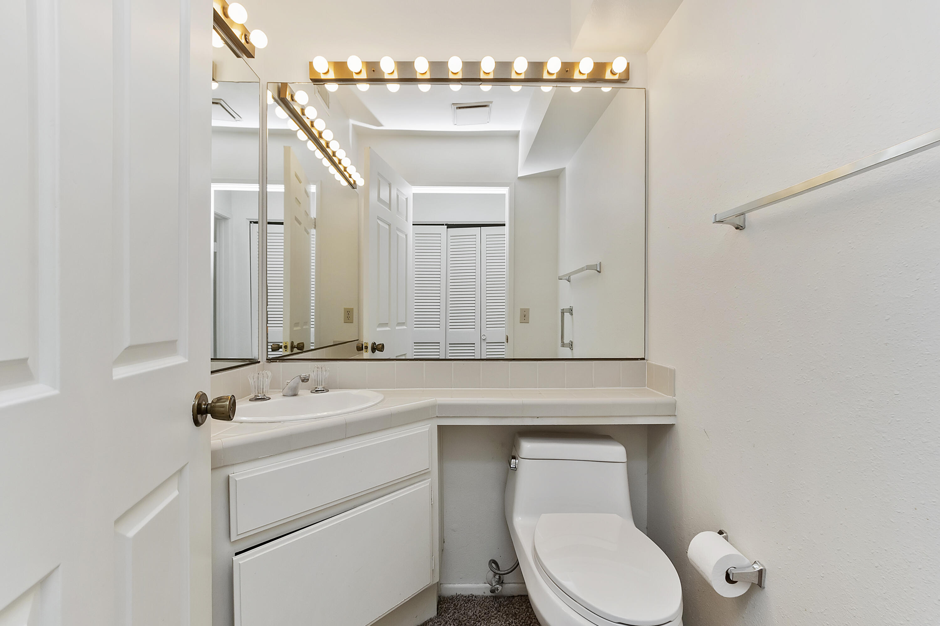 73472 Shadow Mountain Drive Palm Desert, CA 92260 - Photo 16 of 35 a bathroom with a toilet sink vanity and mirror