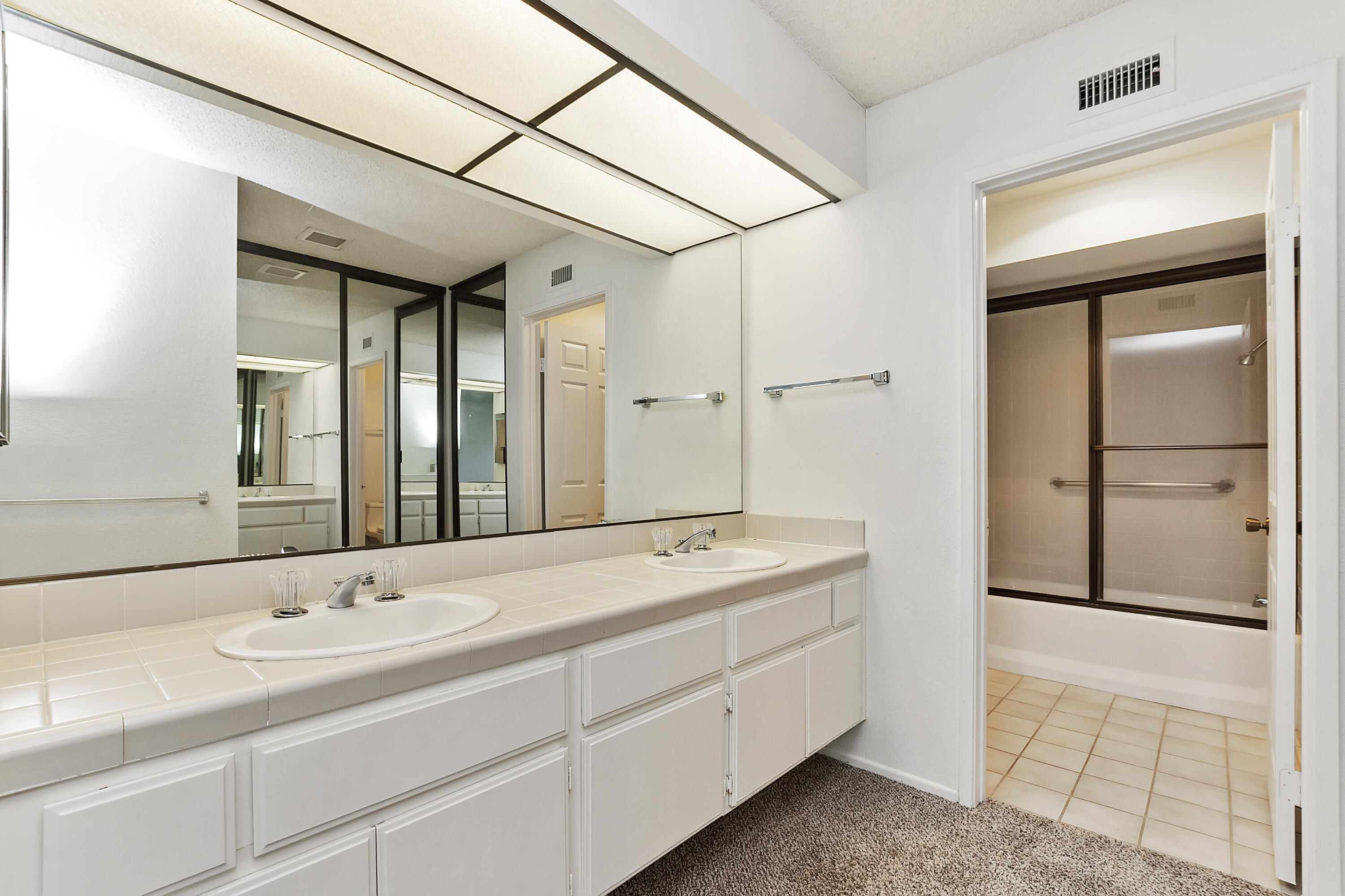73472 Shadow Mountain Drive Palm Desert, CA 92260 - Photo 20 of 35 a bathroom with a double vanity sink and mirror