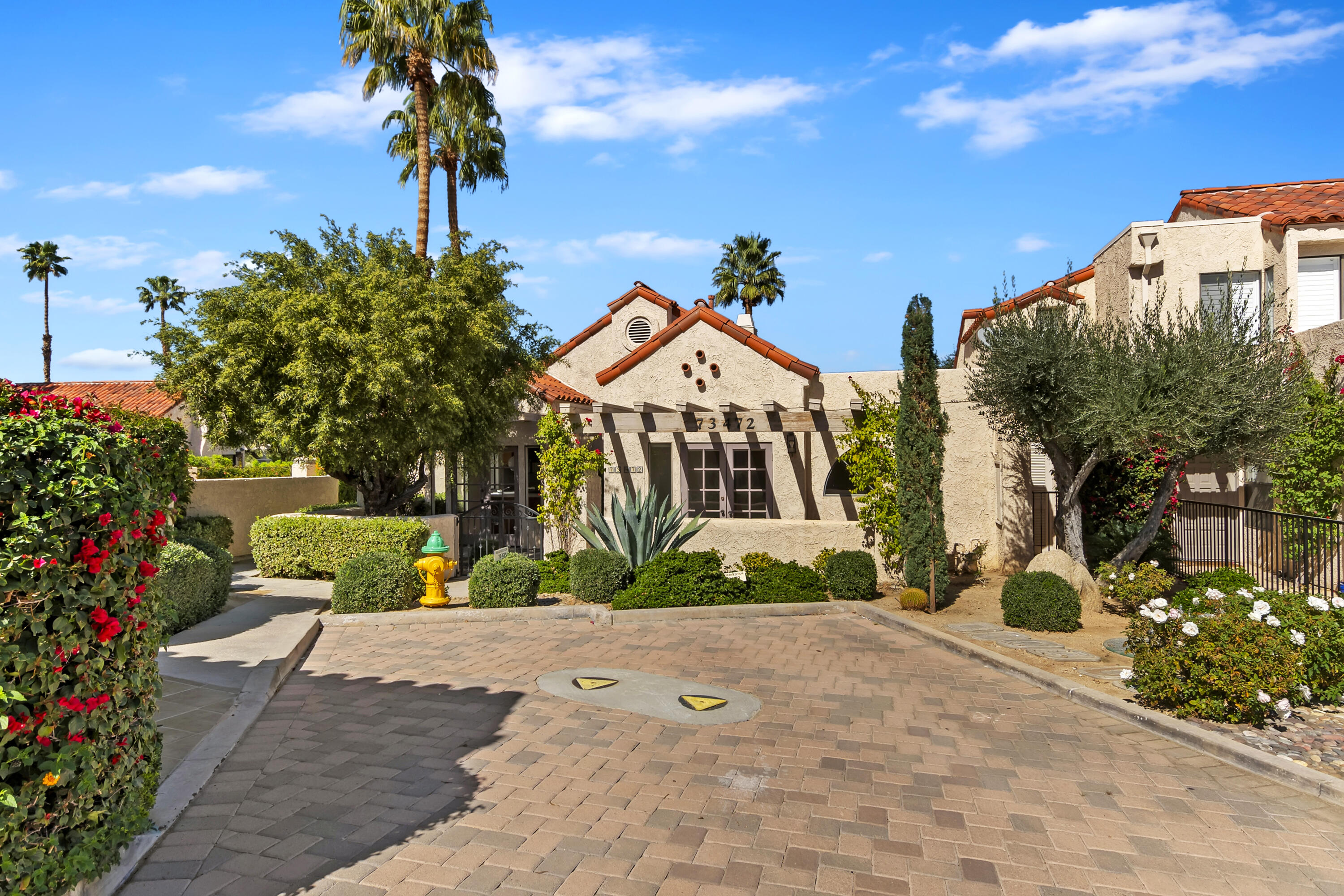 73472 Shadow Mountain Drive Palm Desert, CA 92260 - Photo 2 of 35 a front view of a house with a yard