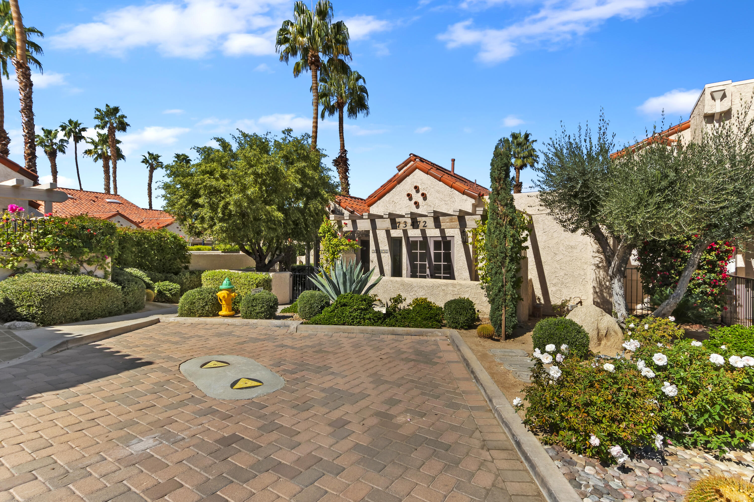 73472 Shadow Mountain Drive Palm Desert, CA 92260 - Photo 3 of 35 a view of a house with a yard and potted plants