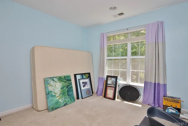 a view of a livingroom with furniture window and a kitchen