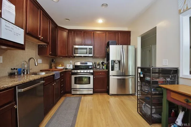a kitchen with a refrigerator stove and sink