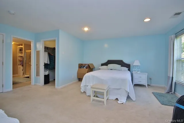 a bedroom with a bed and a mirror