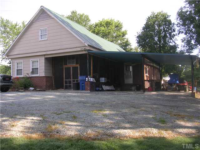 301 Rolling Hills Road Roxboro, NC 27574 - Photo 10 of 16 a view of a house with a yard and plants