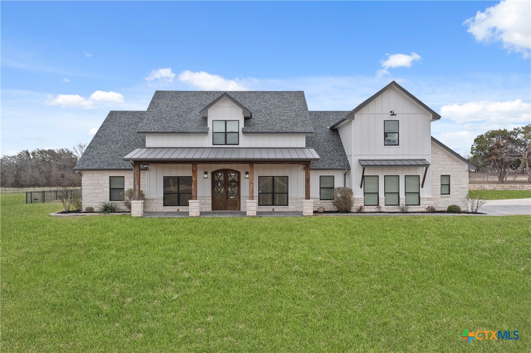 a front view of a house with a garden