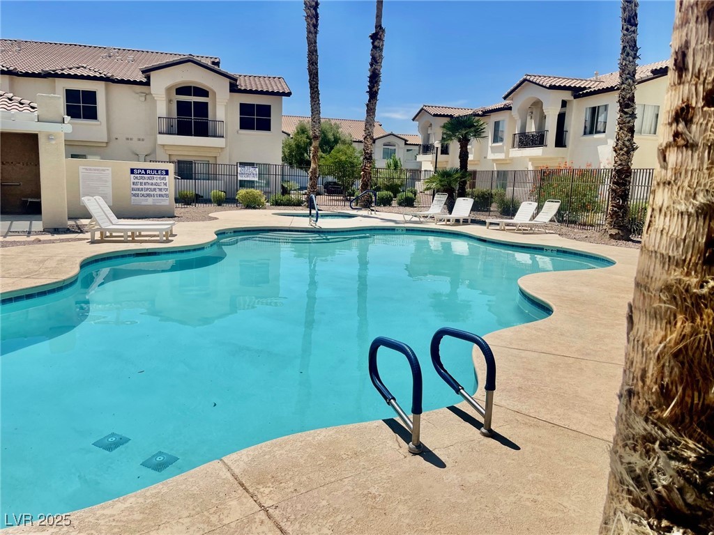 4810 Grey Wolf Lane, Unit 101 Las Vegas, NV 89149 - Photo 5 of 7 Community pool featuring a patio and a residential view