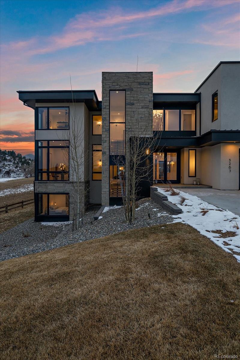 5263 Creation Rock Trail Morrison, CO 80465 - Photo 2 of 50 a front view of a house with a yard