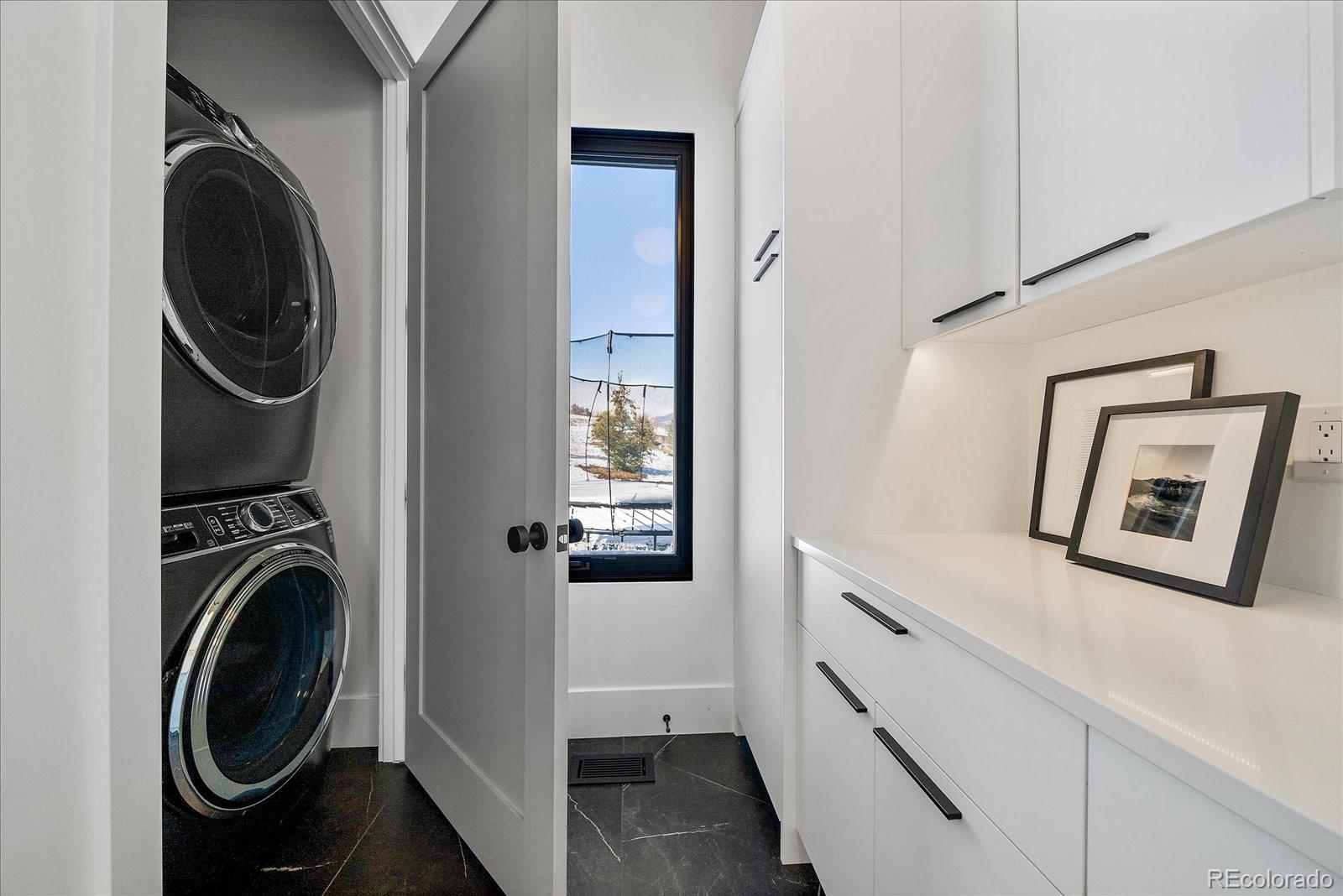 5263 Creation Rock Trail Morrison, CO 80465 - Photo 28 of 50 a view of a storage and utility room with washer and dryer