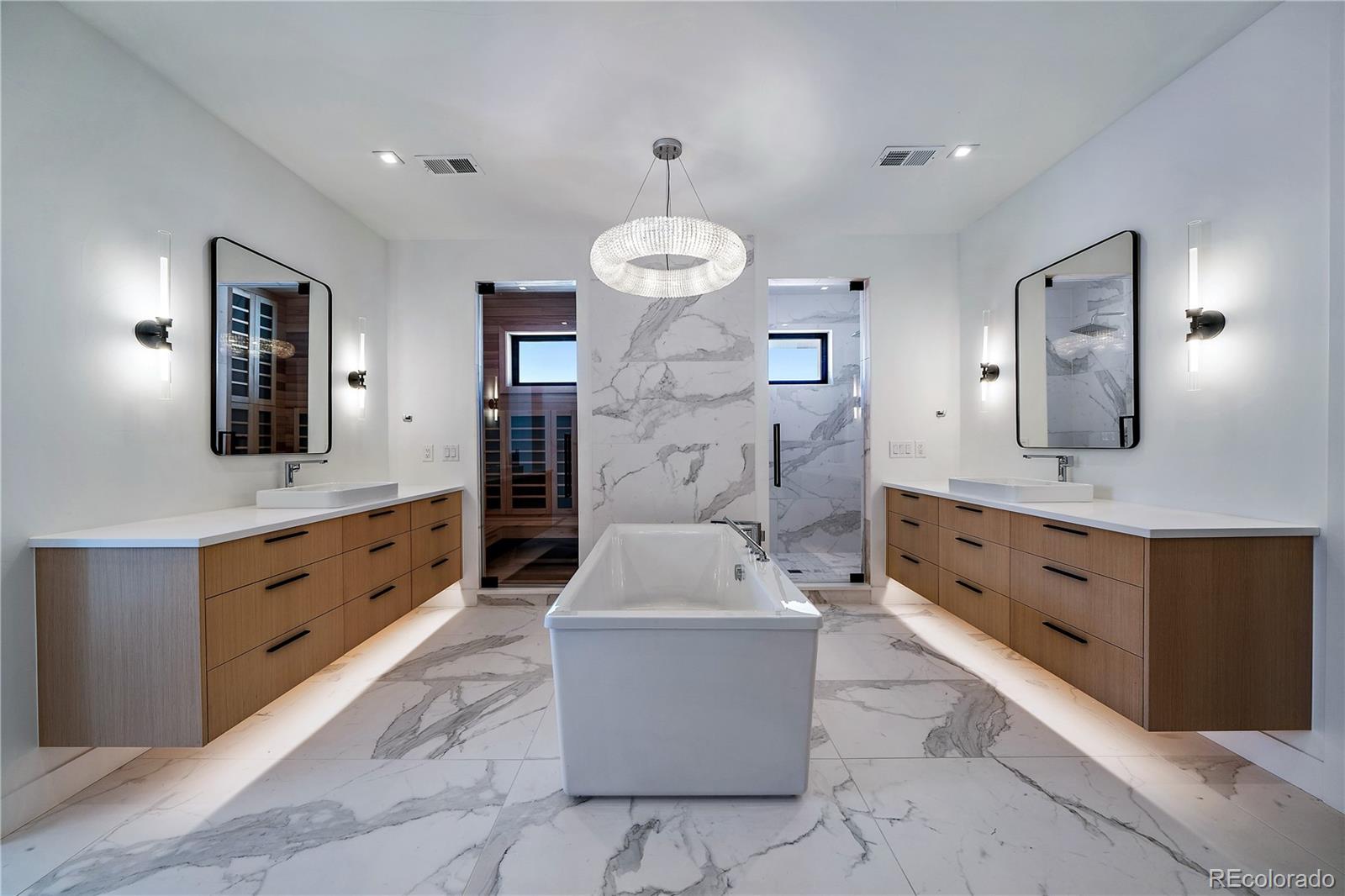 5263 Creation Rock Trail Morrison, CO 80465 - Photo 31 of 50 a large bathroom with a double vanity sink a mirror a bathtub and shower