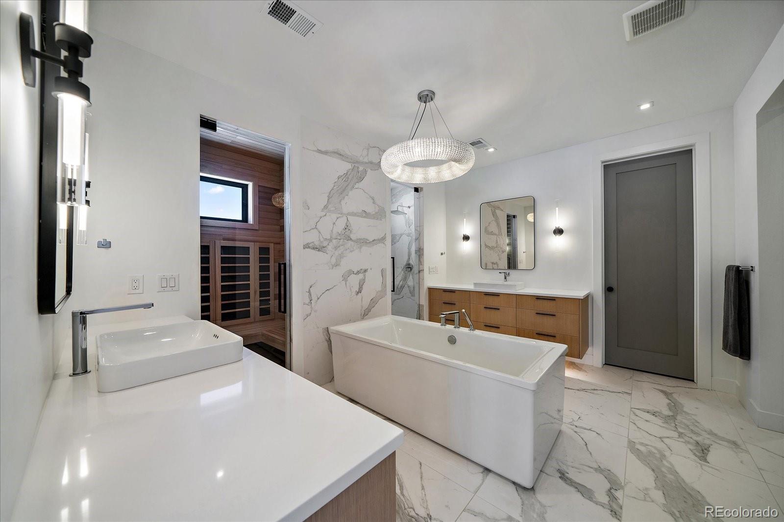 5263 Creation Rock Trail Morrison, CO 80465 - Photo 32 of 50 a bathroom with a sink a tub and a mirror