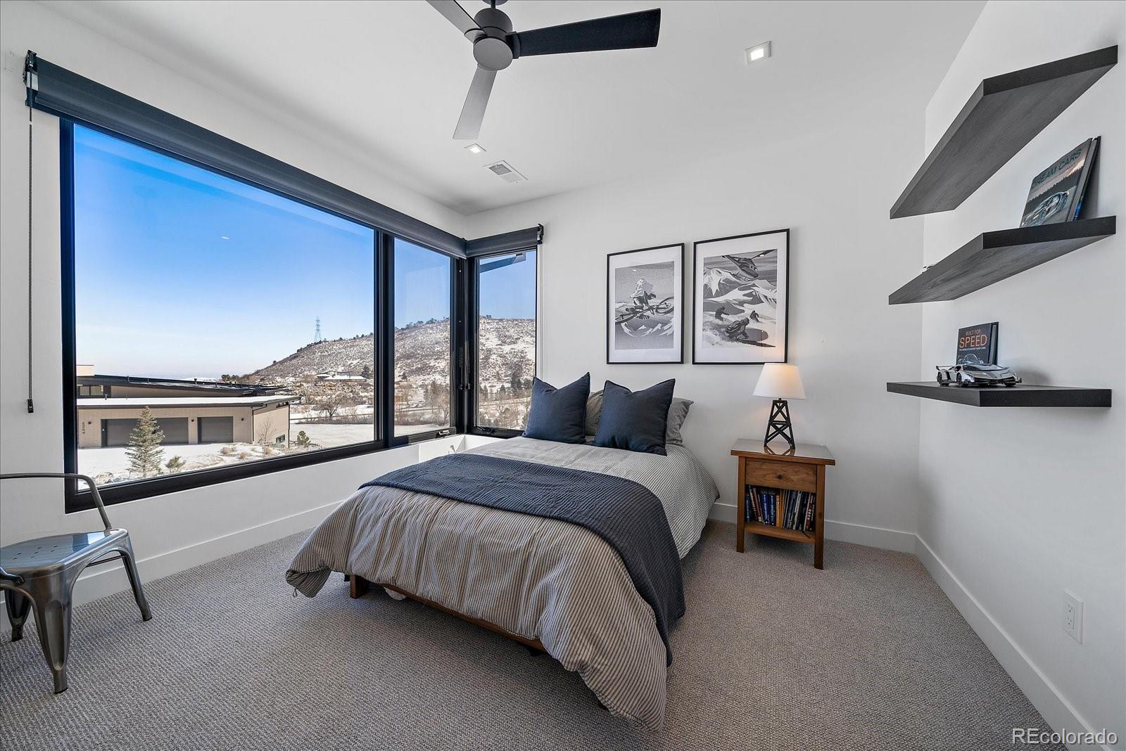5263 Creation Rock Trail Morrison, CO 80465 - Photo 36 of 50 a spacious bedroom with a bed and a large window