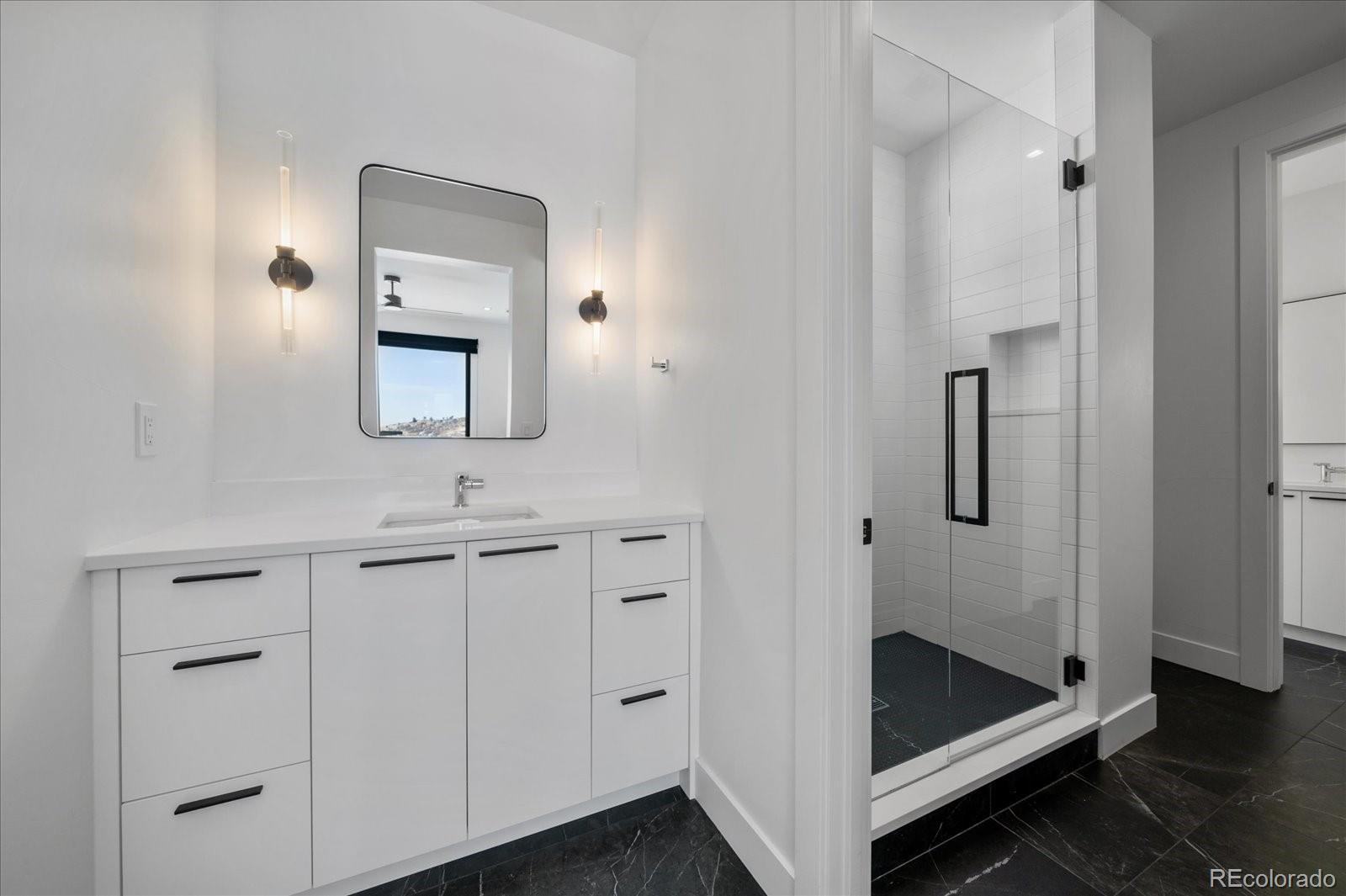 5263 Creation Rock Trail Morrison, CO 80465 - Photo 37 of 50 a bathroom with a tub and a sink