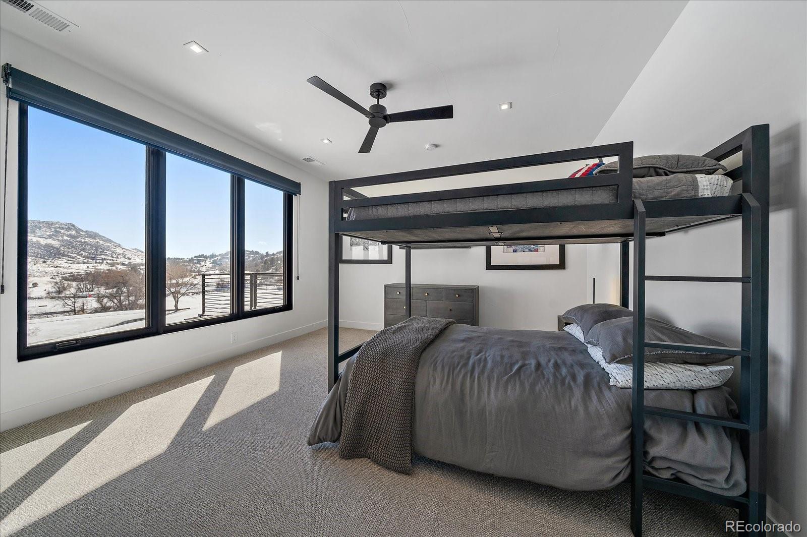 5263 Creation Rock Trail Morrison, CO 80465 - Photo 38 of 50 a bed room with a bed and a large window