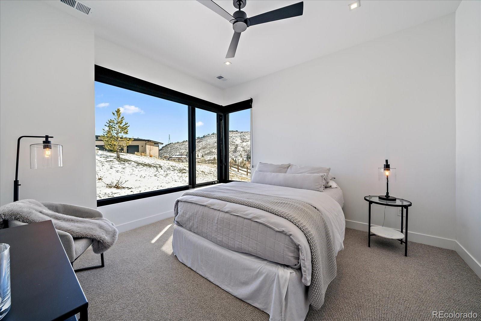 5263 Creation Rock Trail Morrison, CO 80465 - Photo 47 of 50 a bedroom with a bed and a flat screen tv