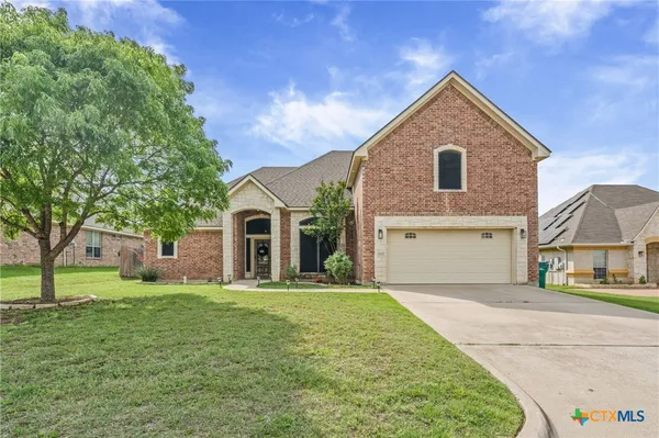a front view of a house with a yard and garage