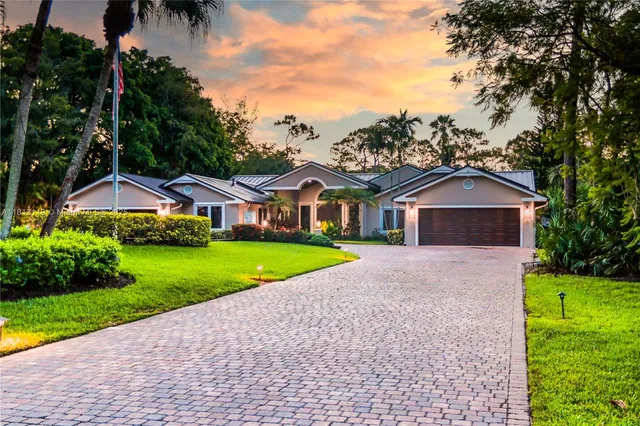 a front view of house with yard and green space