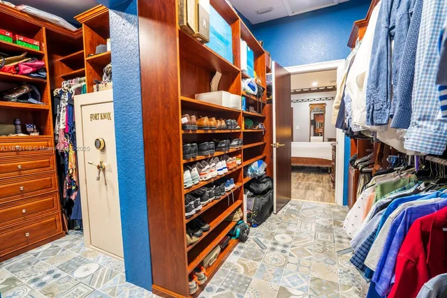 a view of walk in closet and empty room