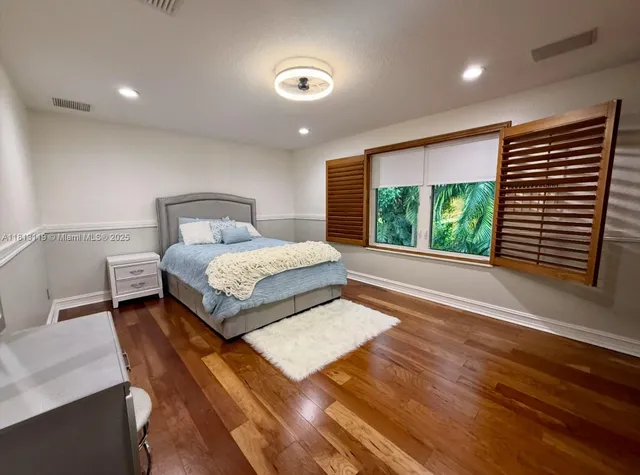 a view of yard with swimming pool and green space