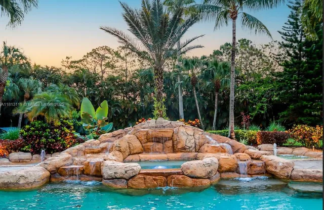 a patio with a table and chairs under an umbrella