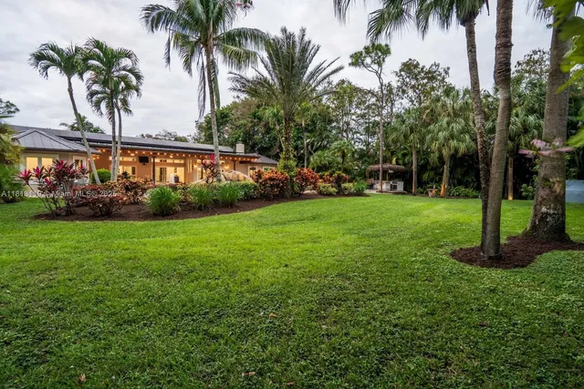 an aerial view of residential houses with outdoor space and street view
