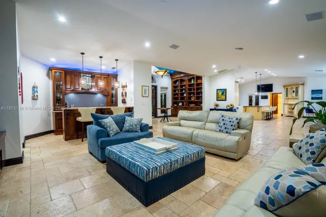 a living room with furniture and kitchen view