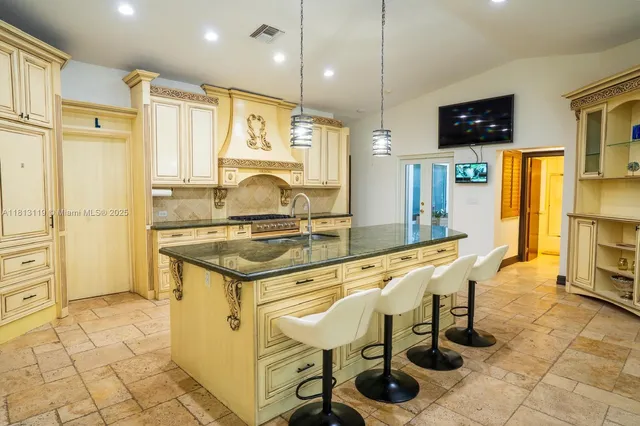 a kitchen with granite countertop cabinets and refrigerator