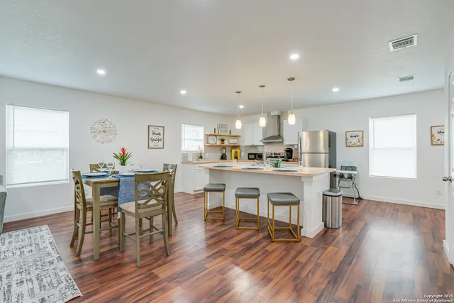 a view of a dining area with furniture and wooden floor