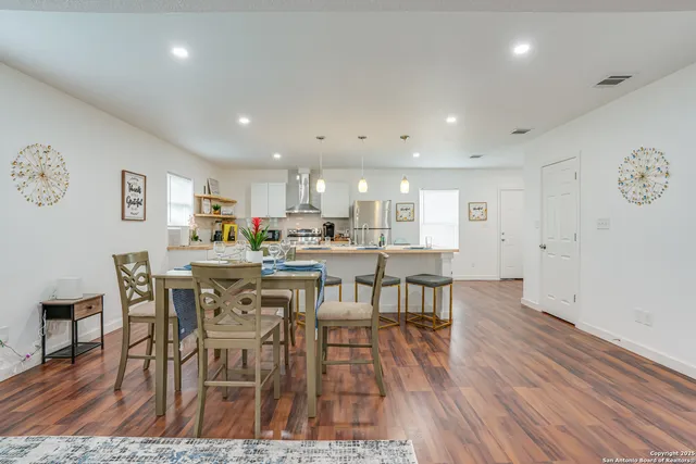 a kitchen with a table and chairs in it