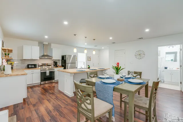 a view of a dining room with furniture and wooden floor