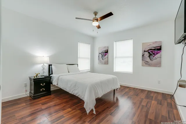a bedroom with a bed and wooden floor